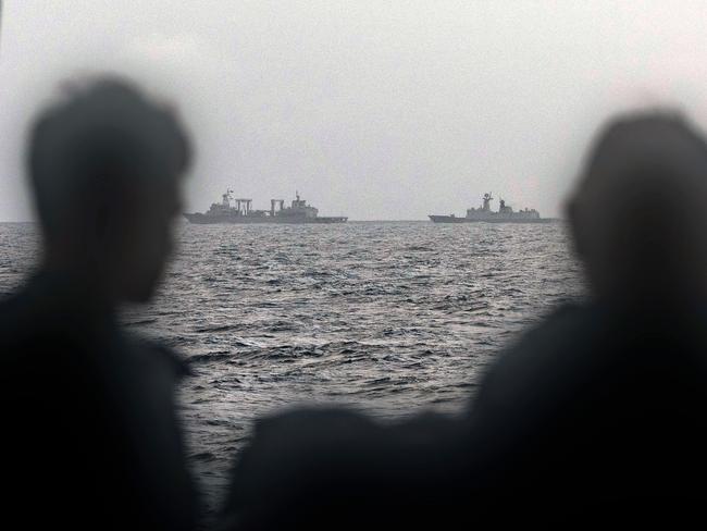 Sailors onboard the Royal Australian Navy ship HMAS Arunta looking at the People's Liberation Army-Navy (PLA-N) Fuchi-class replenishment vessel and Weishanhu Jiangkai-class frigate Hengyang in the Tasman Sea. Picture: ADF