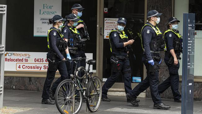 Police patrol empty streets in Melbourne. Picture: Daniel Pockett