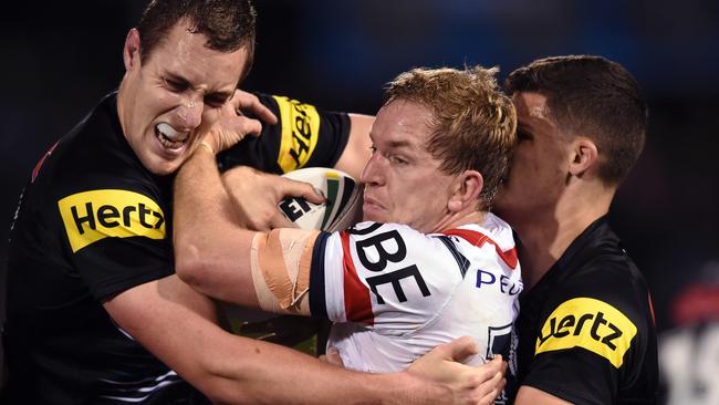 Rooster Mitch Aubusson is the centre of a Panther sandwich during the round 22 NRL match against Penrith at Pepper Stadium. Picture: Paul Miller AAP.