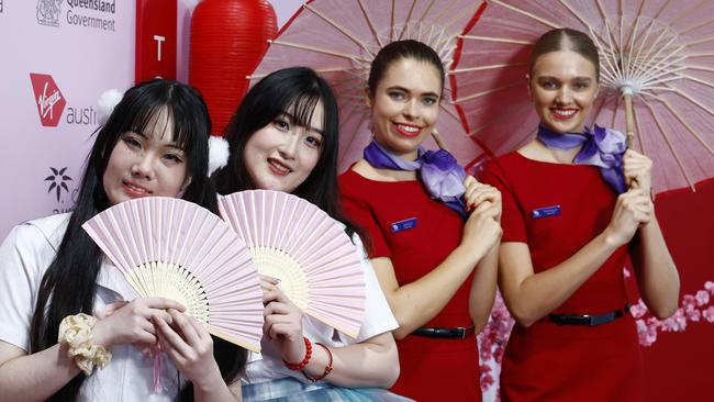 Virgin Australia cabin crew Tally Walling-Scott and Sharmey Sharman with the Melbourne Miaos dancers Minhan Huang and Hanyue Xue to celebrate the launch of Cairns-Tokyo flights. Picture: Brendan Radke