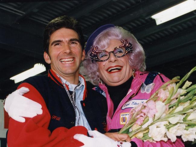 Humphries as Dame Edna Everage with British racing driver Damon Hill in the pits at the Australian Grand Prix in Adelaide, 1993.