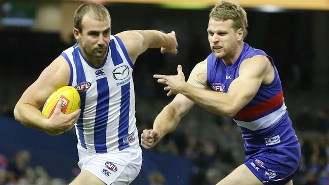 Ben Cunnington gives Jake Stringer the slip. Picture: Michael Klein