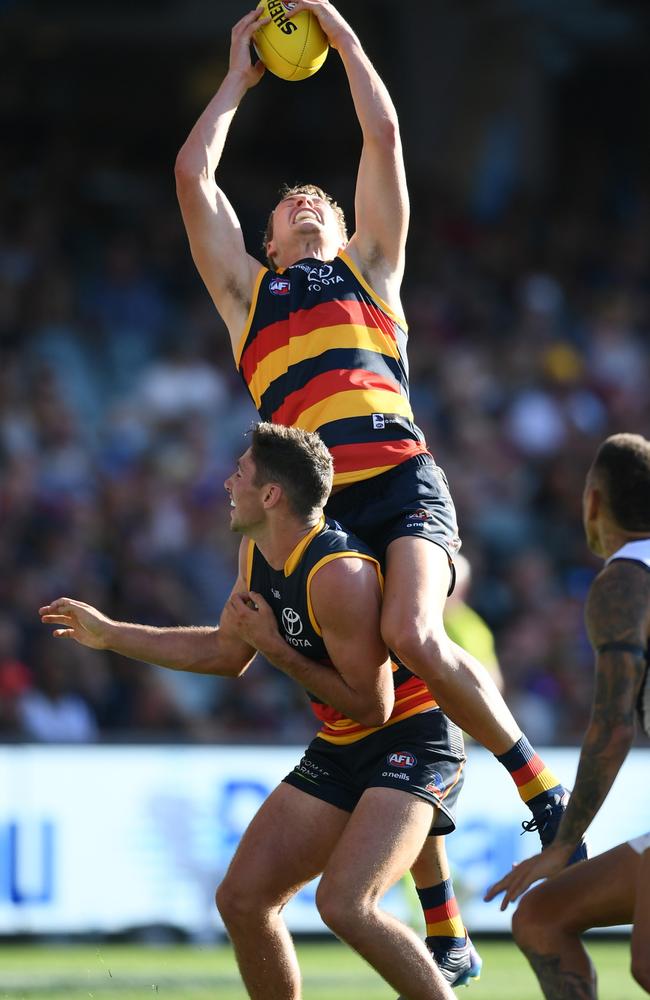 Jordan Dawson of the Crows marks over Chayce Jones