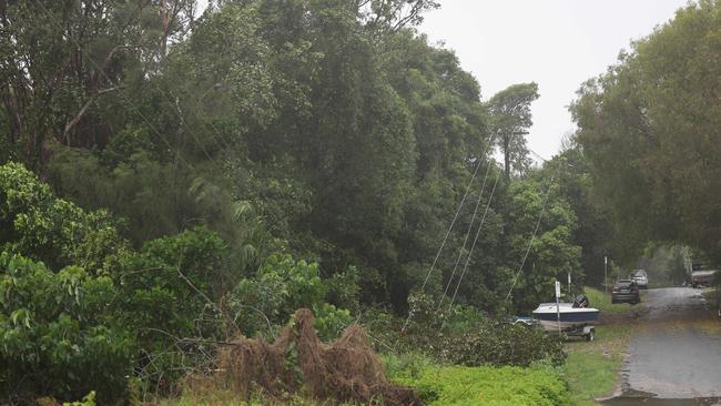 Power lines are down on Cavanbah Street in Byron Bay on Friday morning. Picture: Rohan Kelly