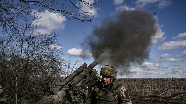 Ukrainian servicemen fire at Russian positions with a 105mm howitzer in the Donbas region this week.