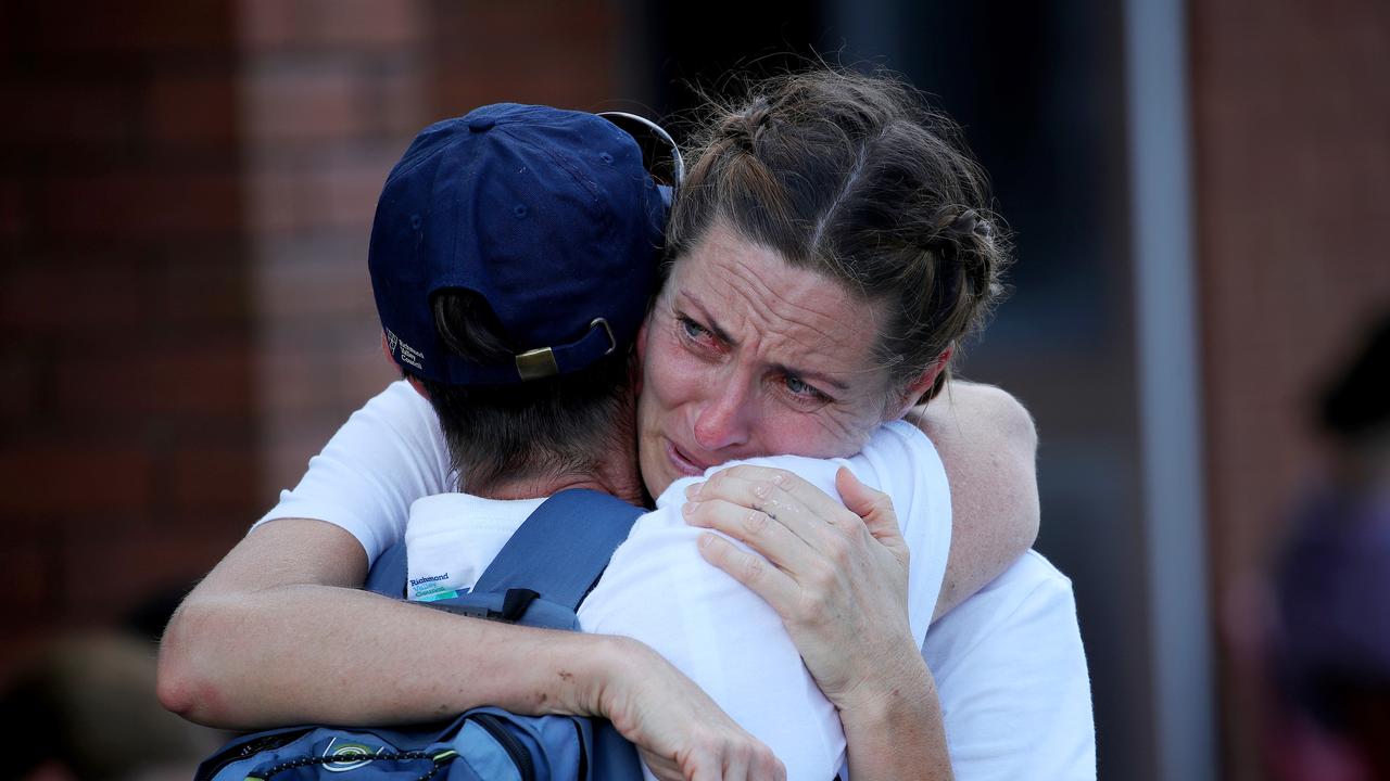 Lismore local Melanie James is consoled by a friend in Coraki. Picture: Toby Zerna