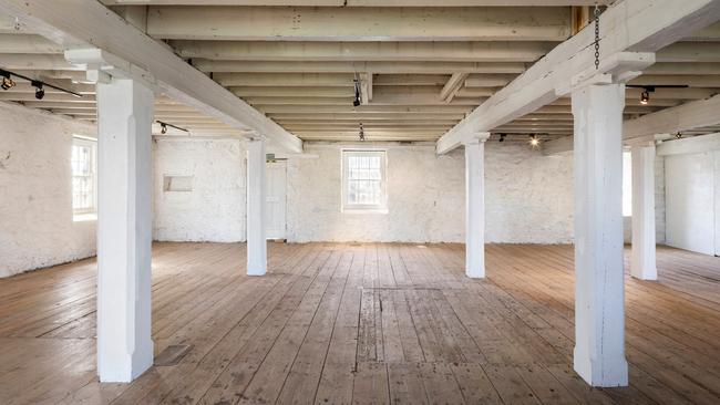 Exposed beams and brickwork feature inside.