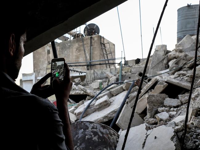 A Syrian gamer uses Pokemon catches a Pokemon amidst the rubble in the besieged rebel-controlled town of Douma. Picture: AFP