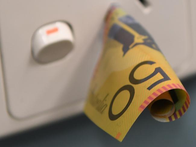 A $50 note is seen inserted into a power point. Malcolm Turnbull has been urged to squarely focus on making power cheaper as he seeks cabinet and party room support for a long-term energy policy. Picture: AAP