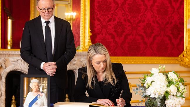 Prime Minister Anthony Albanese and partner Jodie Haydon, signing a book of condolence at Lancaster House. Picture: AFP