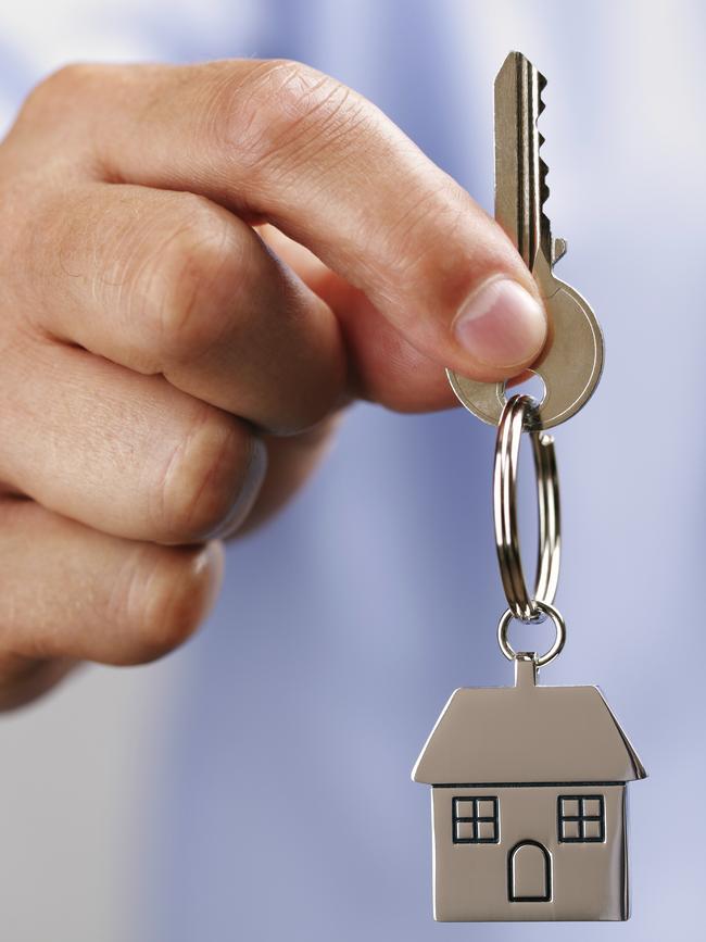 Holding out house keys on a house shaped keychain. Istock photo free to use.