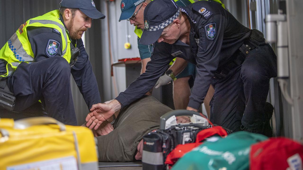 QPS Senior Sergeant Jason Hopgood deals with an unruly man in the trauma response training exercise at the Queensland Fire and Emergency Services Charlton Station. Picture: Nev Madsen.