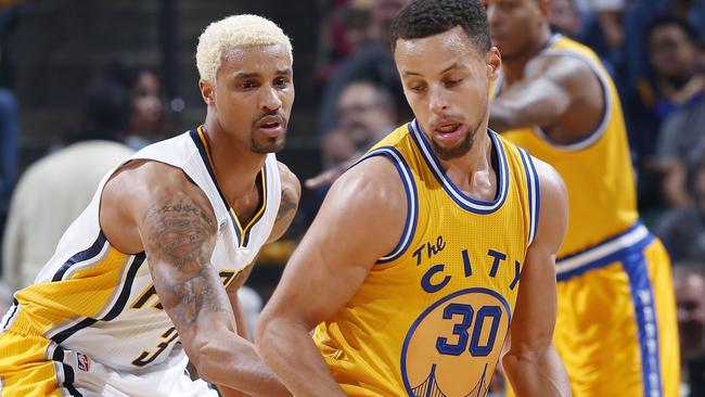 Stephen Curry of the Golden State Warriors handles the ball against George Hill #3 of the Indiana Pacers in the first half.