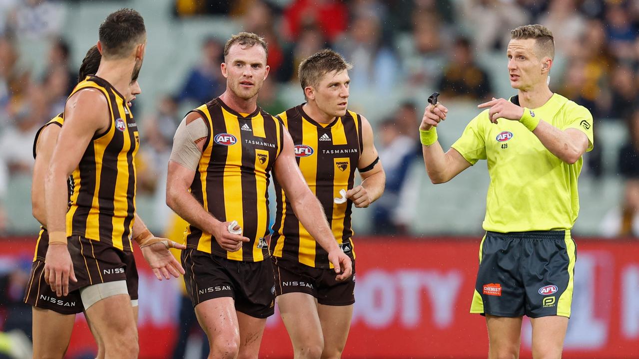 MELBOURNE, AUSTRALIA - APRIL 18: Tom Mitchell of the Hawks speaks with AFL Field Umpire, Hayden Gavine after a 50 metre peanut was awarded to Geelong during the 2022 AFL Round 05 match between the Hawthorn Hawks and the Geelong Cats at the Melbourne Cricket Ground on April 18, 2022 In Melbourne, Australia. (Photo by Michael Willson/AFL Photos via Getty Images)