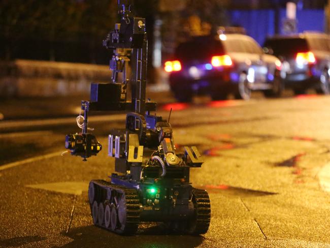 A bomb robot goes in as police secure the scene last night. Picture: Yuri Kouzmin