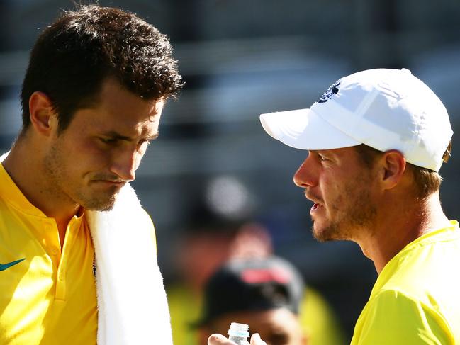 SYDNEY, AUSTRALIA - SEPTEMBER 16:  Bernard Tomic of Australia (L) talks to Captain of Australian Lleyton Hewitt (R) in his singles match against Jozef Kovalik of Slovakia during the Davis Cup World Group playoff between Australia and Slovakia at Sydney Olympic Park Tennis Centre on September 16, 2016 in Sydney, Australia.  (Photo by Matt King/Getty Images)