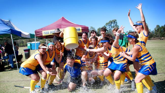 WINNERS: Gympie Veteran womens hockey coach Dave Dixon gets showered in ice water after his team won Division 5 at the state titles in Rockhampton. Photo Craig Warhurst/The Gympie Times