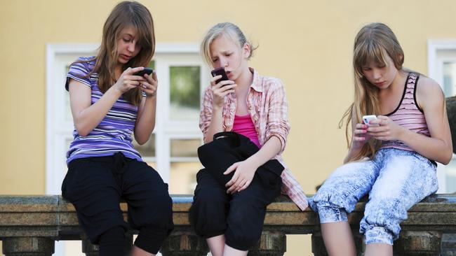 04/11/2012 NEWS: Teenage girls, students texting on mobile phones, text message, school. Generic, thinkstock Pic. Supplied