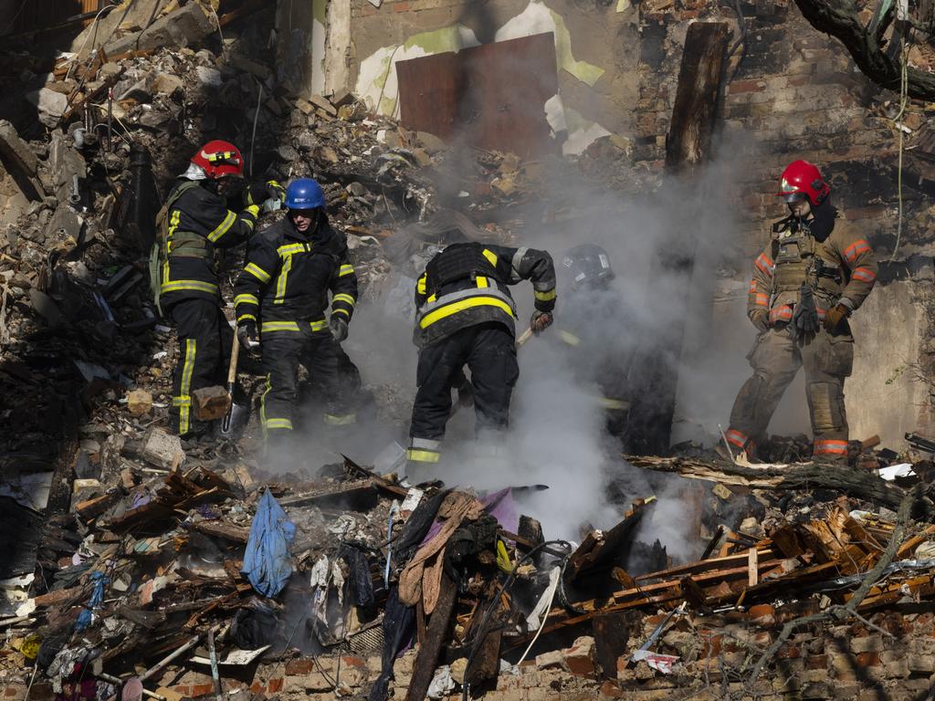 Firefighters appear on the scene to put out a fire in a residential building after a "kamikaze drone" attack in Kyiv, Ukraine where three people were killed. Picture: Getty Images