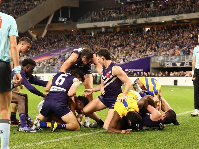 PERTH, AUSTRALIA - AUGUST 13: Players from both teams engage in a melee during the round 22 AFL match between the Fremantle Dockers and the West Coast Eagles at Optus Stadium on August 13, 2022 in Perth, Australia. (Photo by Paul Kane/Getty Images)