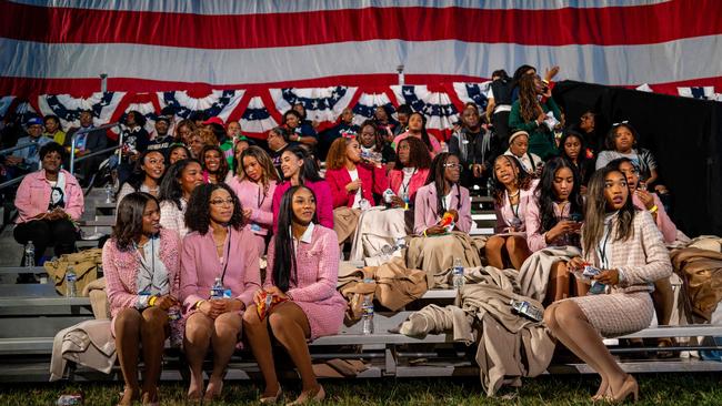 Women with Alpha Kappa Alpha Sorority Inc. sit together ahead of an election night event held by Vice President Kamala Harris at Howard University.