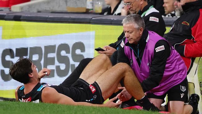 ADELAIDE, AUSTRALIA - APRIL 26: Connor Rozee of the Power on the sidelines in he hands of  trainers during the 2024 AFL Round 07 match between the Port Adelaide Power and the St Kilda Saints at Adelaide Oval on April 26, 2024 in Adelaide, Australia. (Photo by Sarah Reed/AFL Photos via Getty Images)