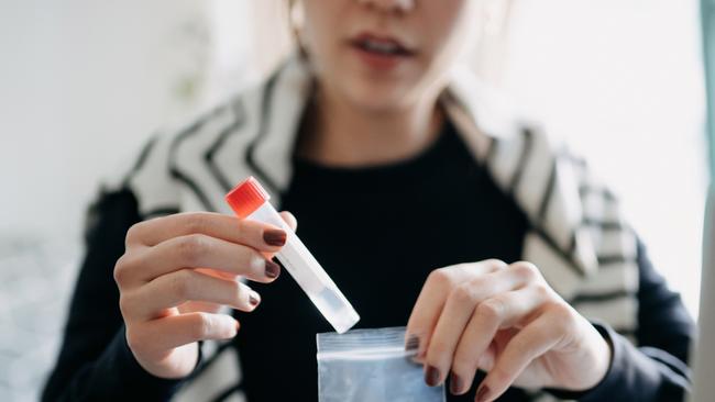 Cropped shot of young Asian woman consulting to her family doctor online in a virtual appointment, holding a medical test tube, conducting Covid-19 diagnostic test at homecredit: getty imagesescape1 august 2021doc holiday