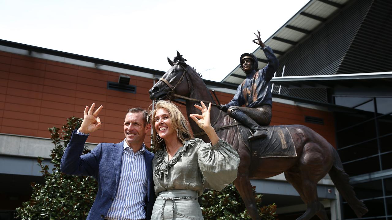 Hugh Bowman and Tanya Bartlett in front of the Winx statue. Picture: Jason McCawley/Getty