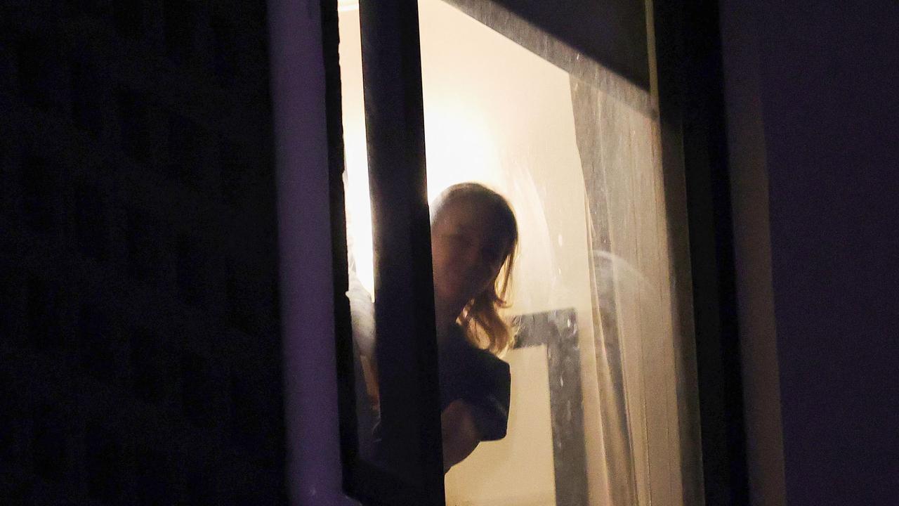 A woman believed to be Voracova looks out the window at the Park Hotel in Carlton. Picture: Con Chronis/AFP