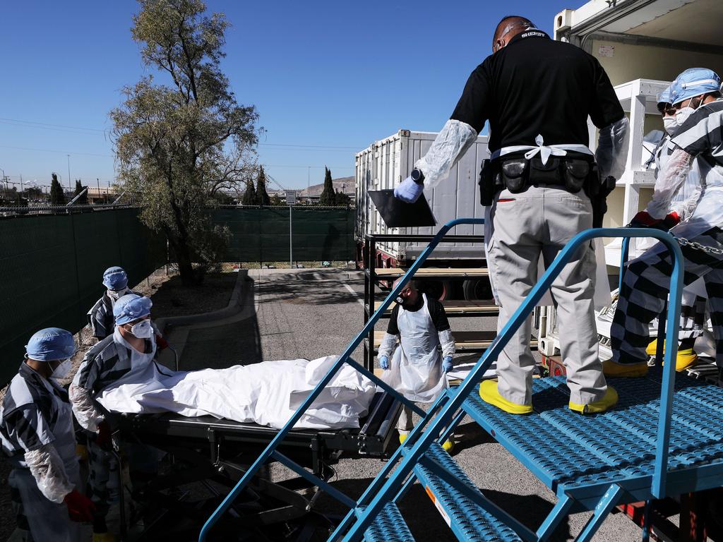 Low-level inmates from El Paso County detention centre load bodies wrapped in plastic Picture: Mario Tama/Getty Images/AFP