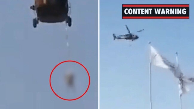 Black Hawk helicopter over Afghanistan with person dangling from below