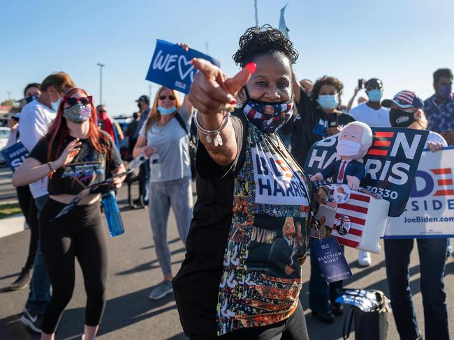 Supporter Faith Green holds a stuffed toy of US President-elect Joe Biden as she and others celebrate his victory outside the Chase Centre in Wilmington, Delaware. Picture: AFP