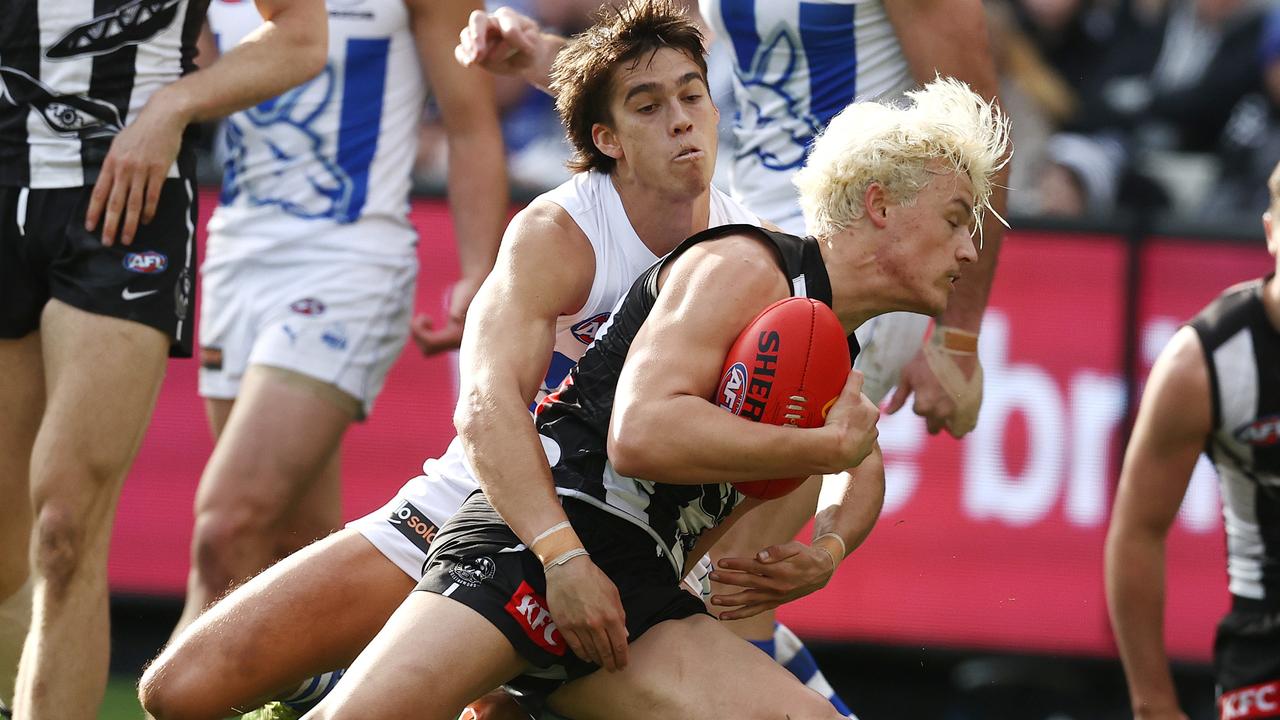 Jack Ginnivan goes low in a tackle against the Kangaroos. Picture: Michael Klein