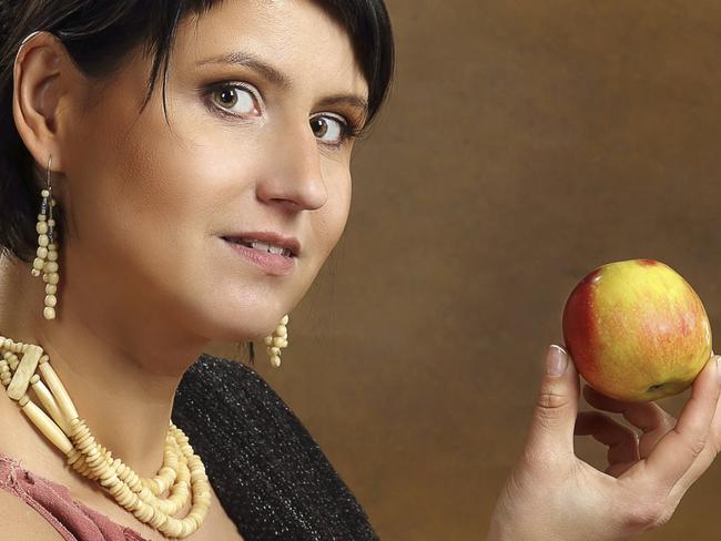 Young Romana with basket full of fruits.