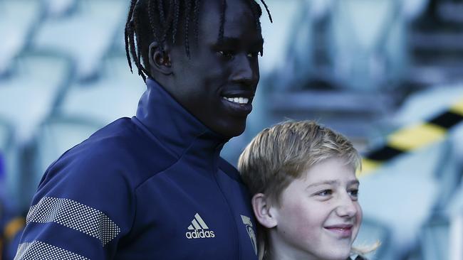 Jiath is already a cult figure with the Hawks as he greets a fan before the match in Launceston. Picture: AFL Photos/via Getty Images