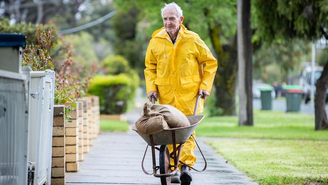 Barry, 82, works to protect his home. Picture: Jason Edwards