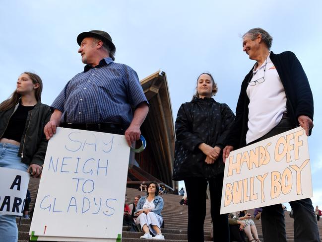 Protesters with placards in an attempt to disrupt The Everst barrier draw light display on the Opera House sails. Picture: Tracey Nearmy