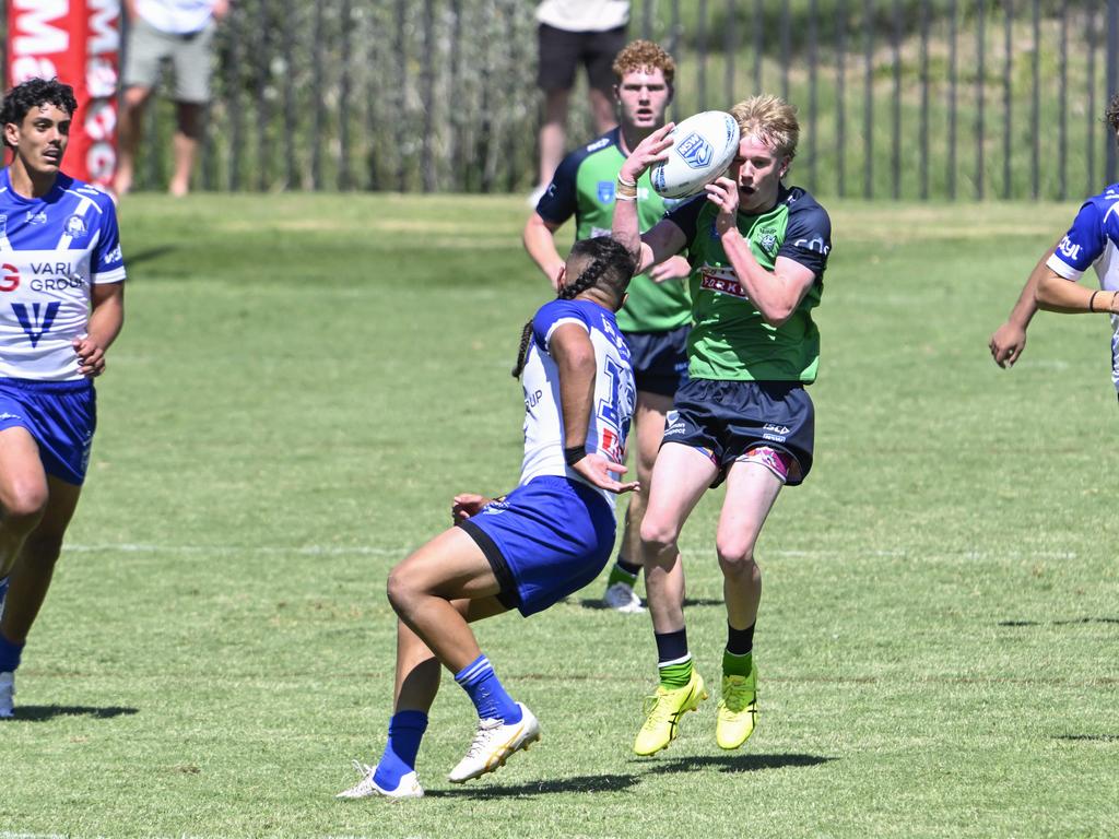 Bailey Logue takes possession as Viliami Mahe watches on. Picture: Martin Ollman