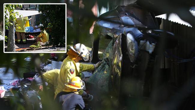 Fire crews cut Tara Brown from her crashed wreck at Molendinar. Photo: Scott Fletcher