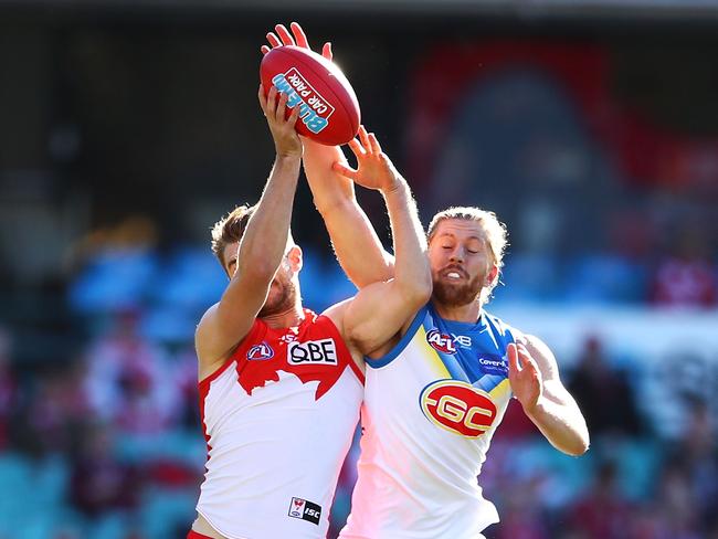 Harrison Marsh of the Swans and Aaron Young of the Suns compete for the ball during the round 18 AFL match between the Sydney Swans and the Gold Coast Suns at Sydney Cricket Ground on July 21, 2018 in Sydney, Australia. (Photo by Mark Kolbe/Getty Images)