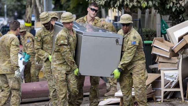 Army personnel help clean-up household waste around the streets of Milton, in Queensland, during Operation Flood Assist 2022. Picture: NewsWire / Sarah Marshall