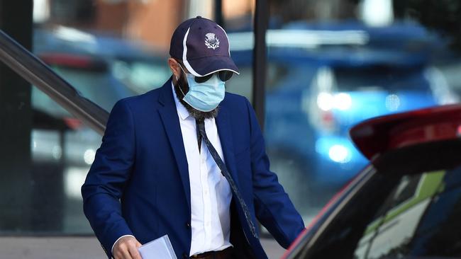 Former Matthew Flinders Anglican College teacher Robert Owen Austin covered his face while leaving Maroochydore District Court on Tuesday. Picture: Sunshine Coast Daily