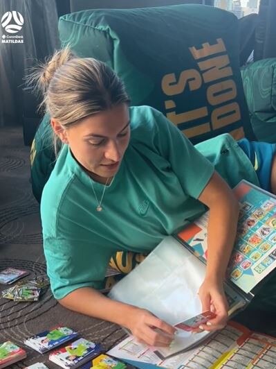 Steph Catley sorts Panini stickers. Picture: Instagram.