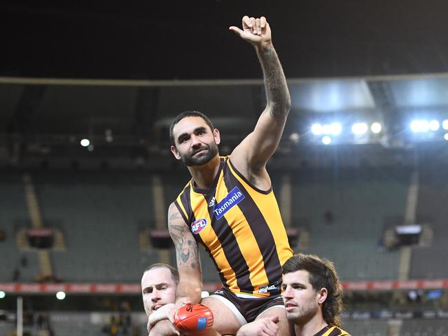 Jarryd Roughhead (left) and Ben Stratton chair Shaun Burgoyne (centre) from the ground after he played his 350th AFL game during the Round 13 AFL match between the Hawthorn Hawks and the Adelaide Crows at the MCG in Melbourne, Saturday, June 16, 2018. (AAP Image/Julian Smith) NO ARCHIVING, EDITORIAL USE ONLY