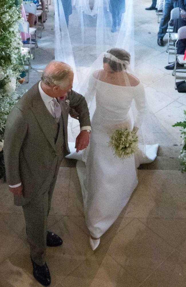 Prince Charles beamed as he greeted Meghan at the start of the aisle. Picture: AFP.