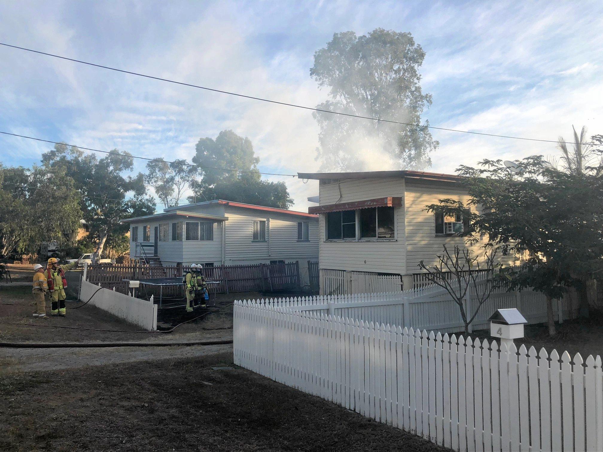 Firefighters at the scene of a house fire on Naughton St, Wandal, this afternoon. Reports indicate the top part of the house is gutted but firefighters are walking in through the front door.