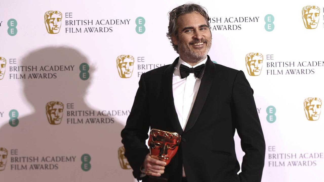 Actor Joaquin Phoenix poses with his award for Best Actor for the film Joker. Picture: AP