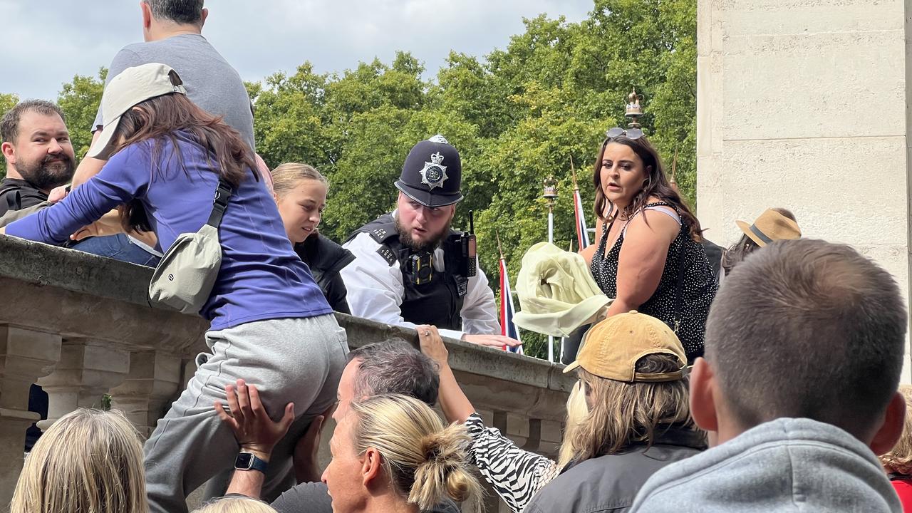 Crowds were so desperate to get a glimpse of the new King they climbed the boundary walls surrounding the palace and the Queen Victoria Memorial. Picture: Chantelle Francis