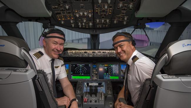 Captain Sean Golding (left seat) and First Officer Jeremy Sutherland are fitted with brain activity monitoring equipment ahead of the historic Qantas test flight from New York to Sydney Picture: Supplied