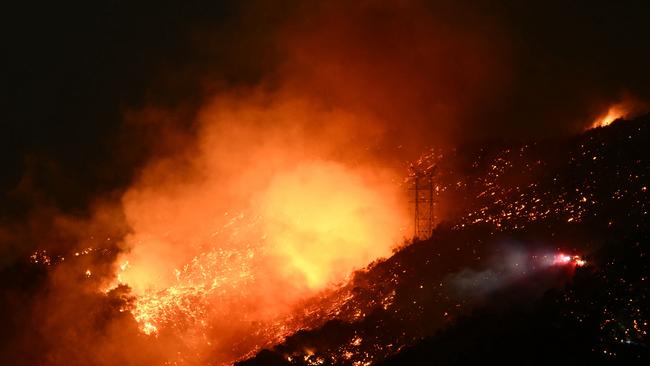 Smoke and flames rise from a hillside at the Palisades fire. Picture: Patrick T. Fallon / AF